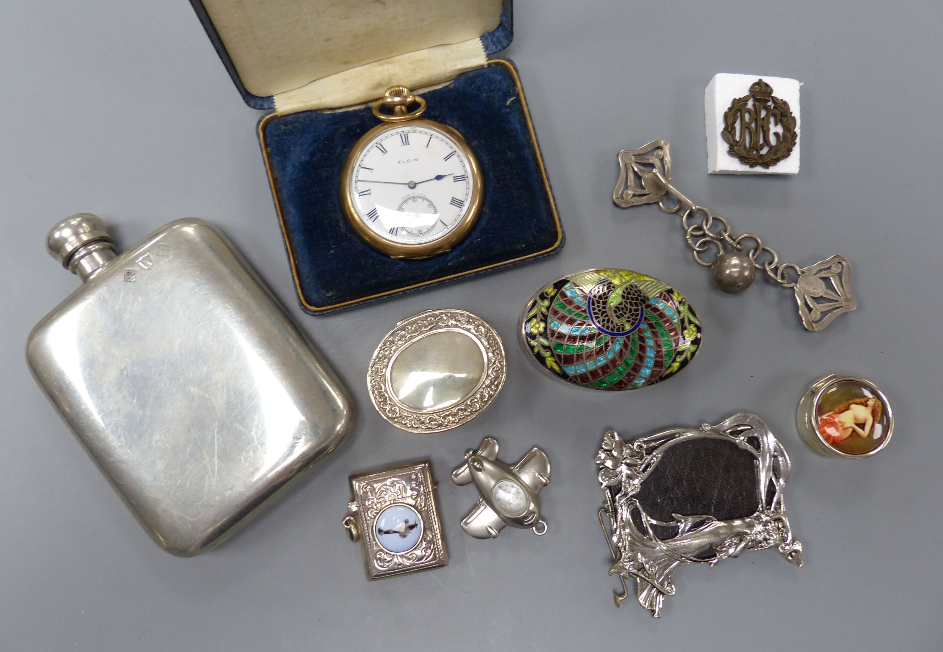 A small group of collectables including gold plated Elgin pocket watch, a 925 and enamel vesta case, three enamelled pill boxes, 'aeroplane' watch pendant, pewter hip flask, photo frame, pair of silver clips and a milita